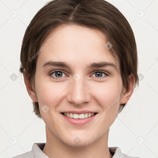 Joyful white young-adult female with short  brown hair and grey eyes