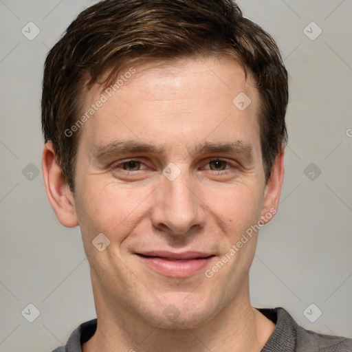 Joyful white adult male with short  brown hair and grey eyes