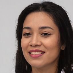 Joyful asian young-adult female with long  brown hair and brown eyes