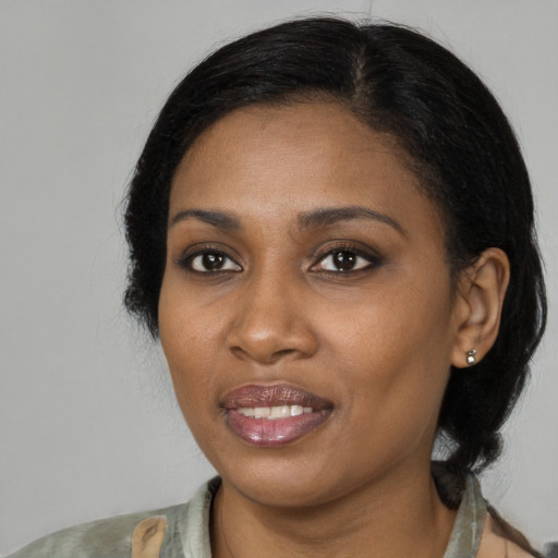 Joyful black young-adult female with medium  brown hair and brown eyes