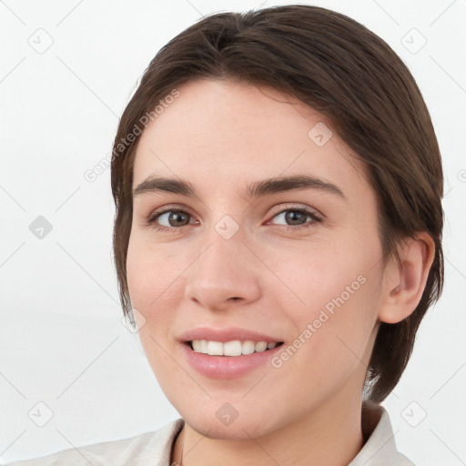 Joyful white young-adult female with medium  brown hair and grey eyes