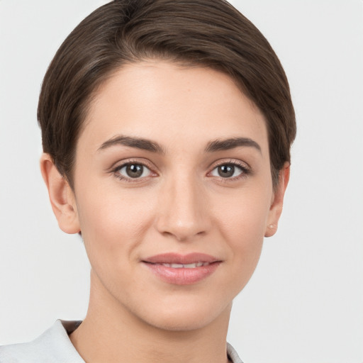 Joyful white young-adult female with short  brown hair and brown eyes