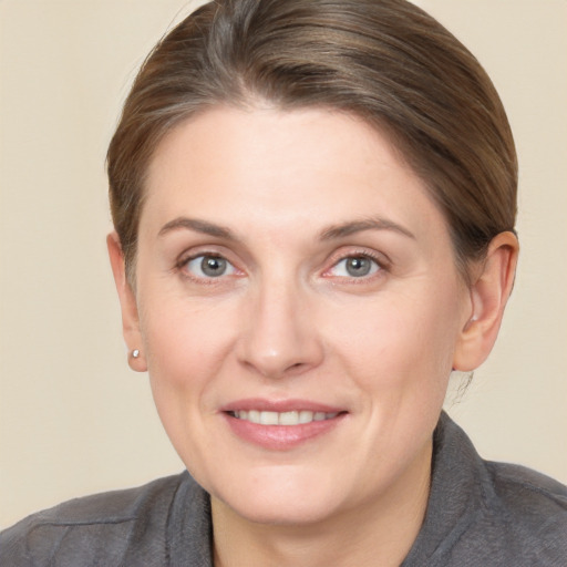 Joyful white adult female with short  brown hair and grey eyes