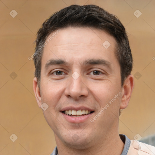 Joyful white adult male with short  brown hair and brown eyes