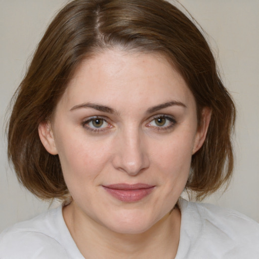 Joyful white young-adult female with medium  brown hair and green eyes