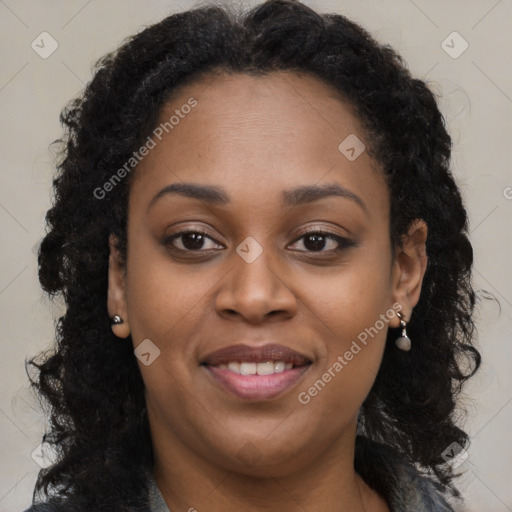 Joyful black young-adult female with long  brown hair and brown eyes