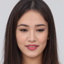 Joyful asian young-adult female with long  brown hair and brown eyes