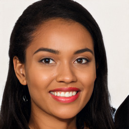 Joyful black young-adult female with long  brown hair and brown eyes