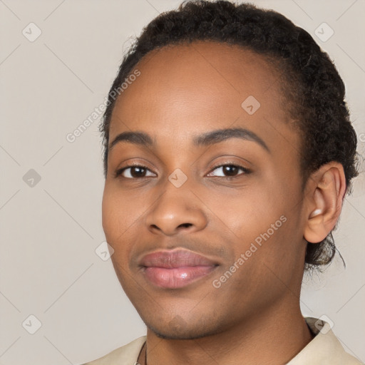 Joyful black young-adult female with short  brown hair and brown eyes