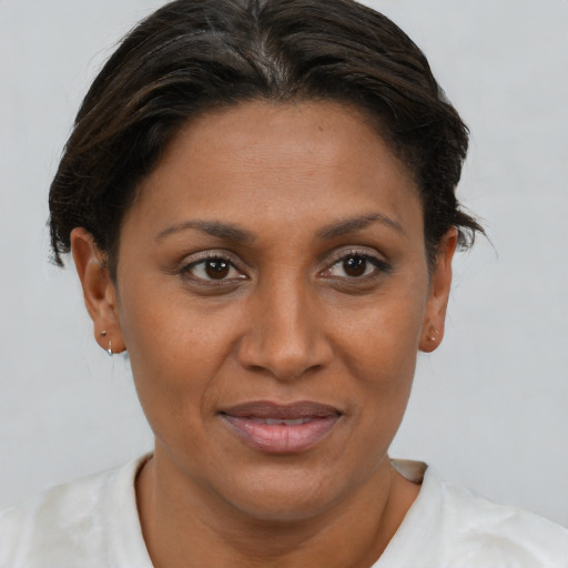 Joyful black adult female with short  brown hair and brown eyes