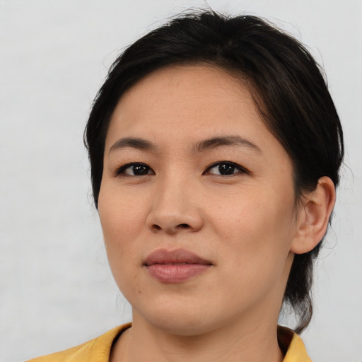 Joyful asian young-adult female with medium  brown hair and brown eyes