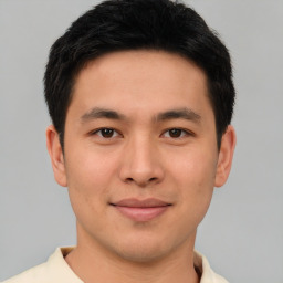 Joyful asian young-adult male with short  brown hair and brown eyes