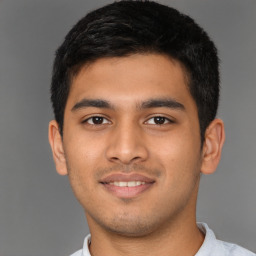 Joyful latino young-adult male with short  brown hair and brown eyes