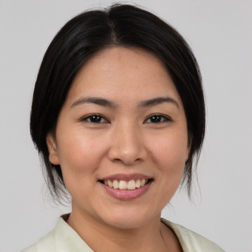 Joyful white young-adult female with medium  black hair and brown eyes
