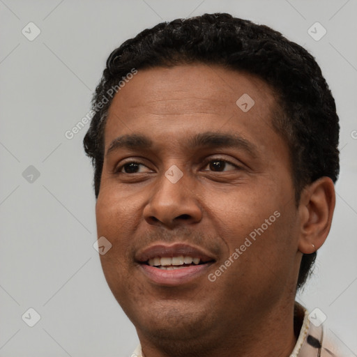 Joyful black young-adult male with short  black hair and brown eyes