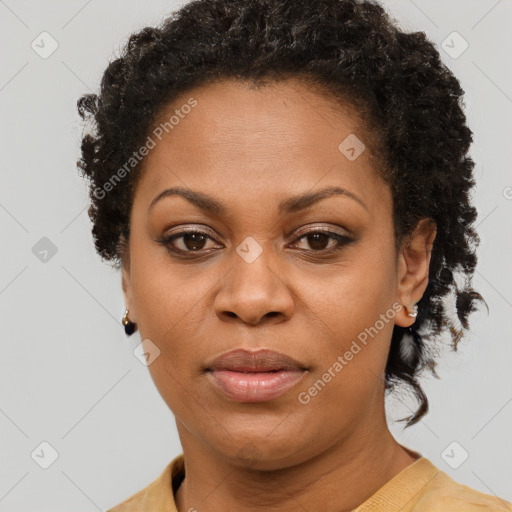 Joyful black adult female with short  brown hair and brown eyes