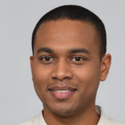 Joyful black young-adult male with short  brown hair and brown eyes
