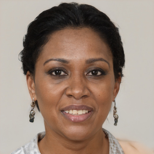 Joyful black adult female with short  brown hair and brown eyes