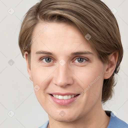 Joyful white young-adult female with medium  brown hair and grey eyes