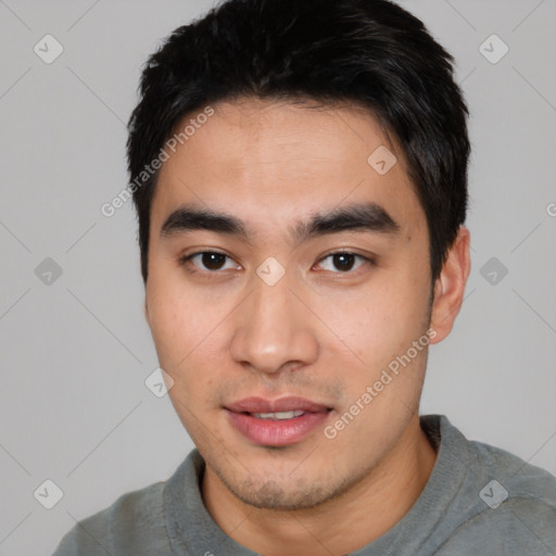 Joyful asian young-adult male with short  black hair and brown eyes