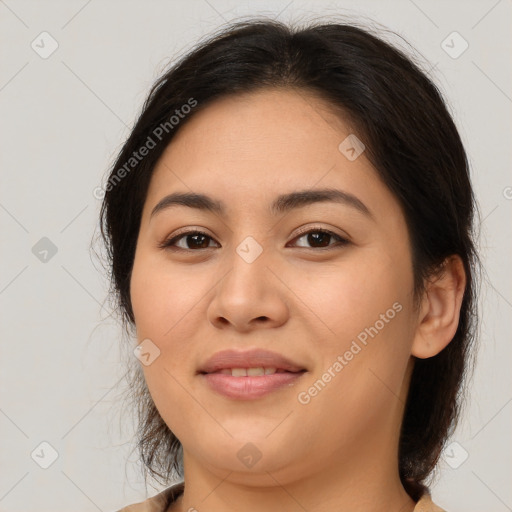 Joyful latino young-adult female with medium  brown hair and brown eyes