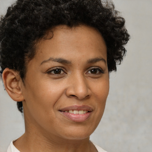Joyful latino young-adult female with short  brown hair and brown eyes
