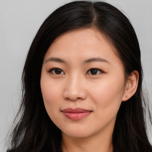 Joyful asian young-adult female with long  brown hair and brown eyes