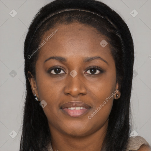 Joyful black young-adult female with long  brown hair and brown eyes