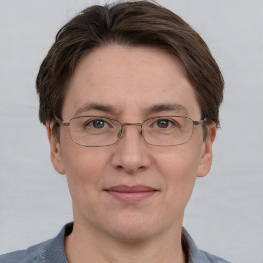 Joyful white adult female with short  brown hair and grey eyes