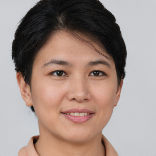 Joyful asian young-adult female with short  brown hair and brown eyes