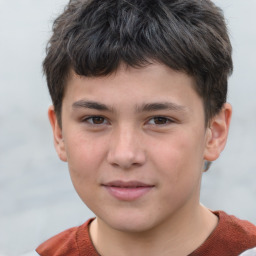 Joyful white child male with short  brown hair and brown eyes