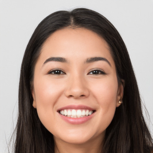 Joyful white young-adult female with long  black hair and brown eyes