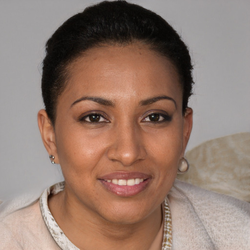 Joyful black young-adult female with short  brown hair and brown eyes
