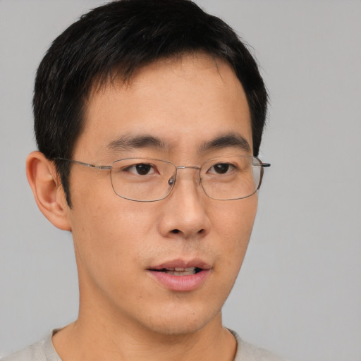 Neutral asian young-adult male with short  brown hair and brown eyes