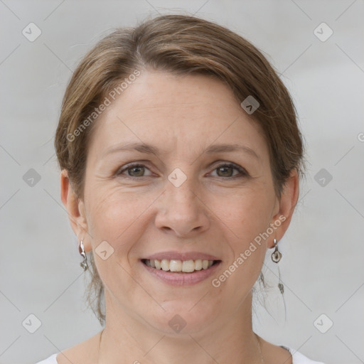 Joyful white adult female with medium  brown hair and grey eyes