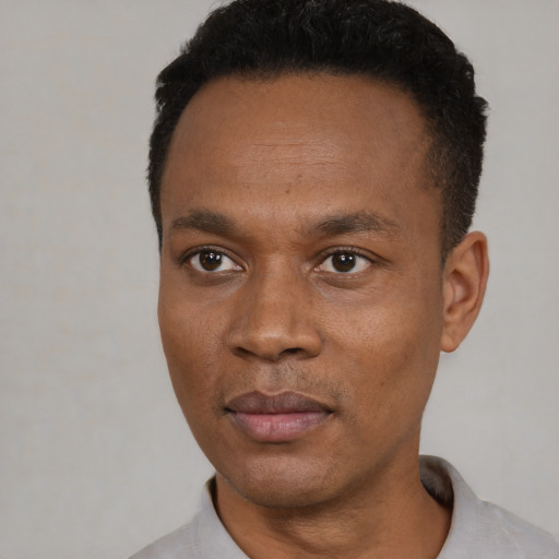 Neutral black young-adult male with short  black hair and brown eyes