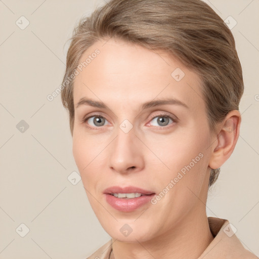 Joyful white young-adult female with short  brown hair and grey eyes