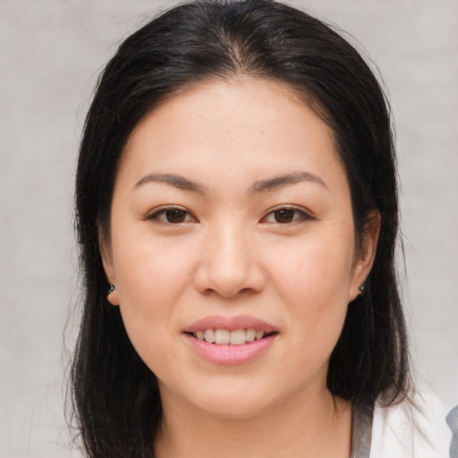 Joyful asian young-adult female with medium  brown hair and brown eyes