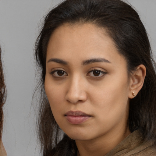 Neutral latino young-adult female with long  brown hair and brown eyes