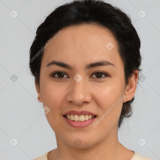 Joyful latino young-adult female with short  black hair and brown eyes