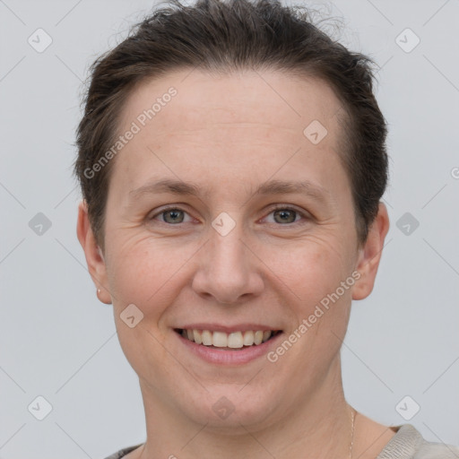 Joyful white adult female with short  brown hair and grey eyes