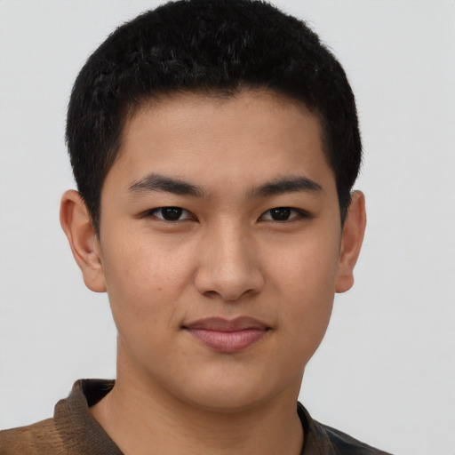 Joyful asian young-adult male with short  brown hair and brown eyes