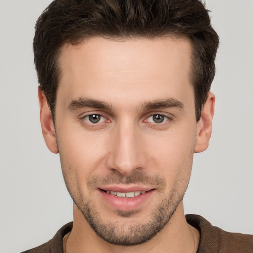 Joyful white young-adult male with short  brown hair and brown eyes