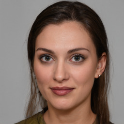 Joyful white young-adult female with medium  brown hair and brown eyes