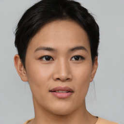 Joyful asian young-adult female with short  black hair and brown eyes