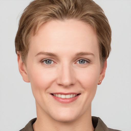 Joyful white young-adult female with short  brown hair and grey eyes