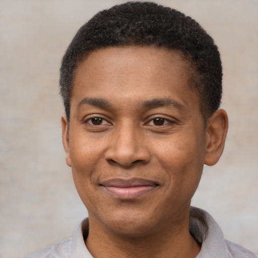 Joyful latino adult male with short  black hair and brown eyes
