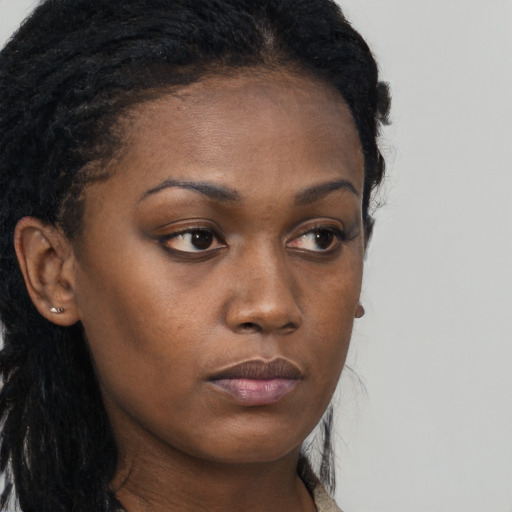Neutral black young-adult female with long  brown hair and brown eyes