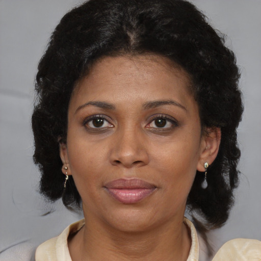 Joyful black adult female with short  brown hair and brown eyes