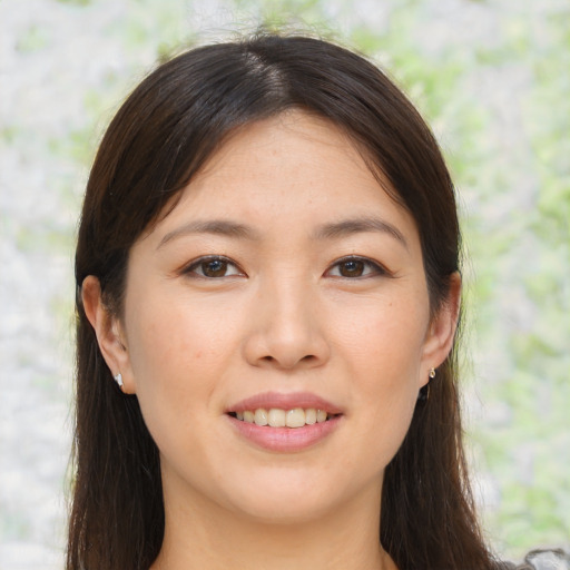 Joyful asian young-adult female with long  brown hair and brown eyes